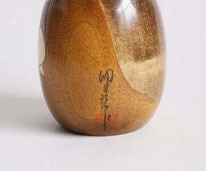 artist's signature on a creative kokeshi